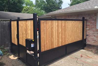 New fence and driveway gate with opener installed in Houston, TX.