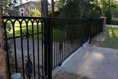 Iron fence Houston, TX style installed estate side entrance.