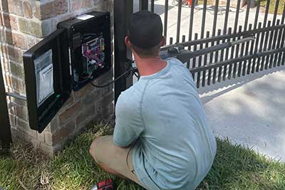 Sentry technician working a LiftMaster gate openers repair service call.