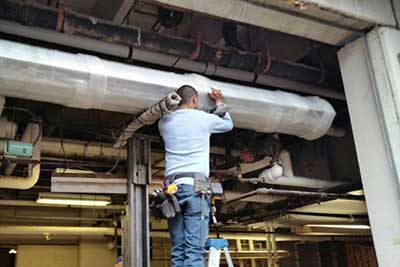 Commercial garage door technician working.