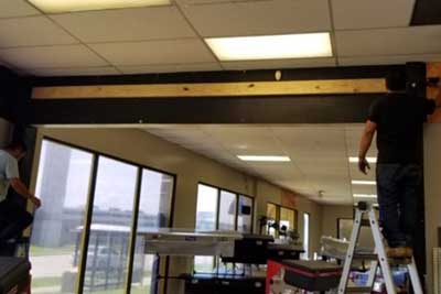 Installing commercial overhead door.