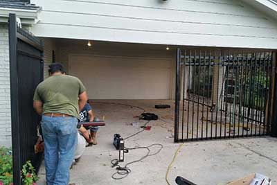 Gate repair in Houston, TX replacing swing gate operator.